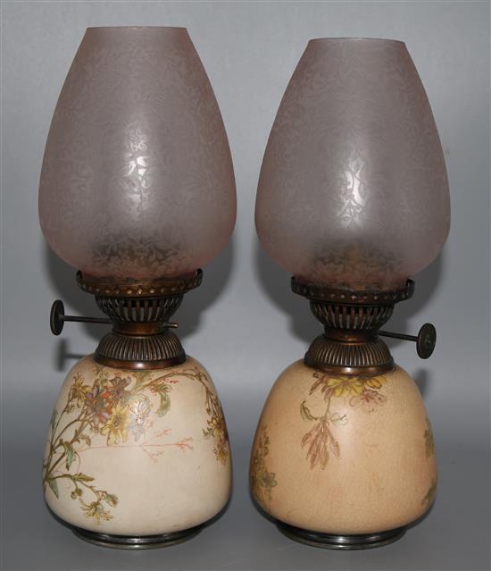 A pair of Doulton Burslem oil lamps with glass shades
